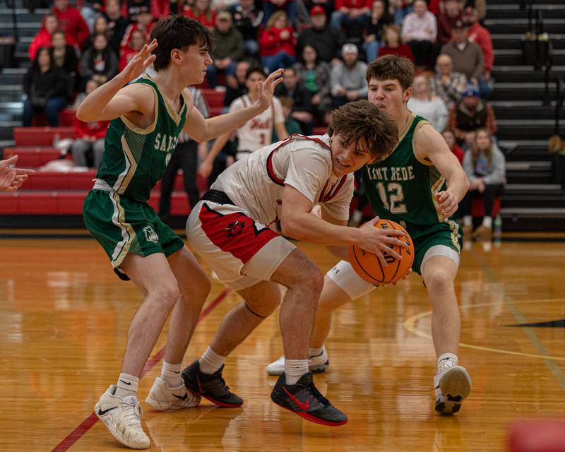 Hall's Greyson Bickett (0) holds ball whilst being surrounded by St. Bede's defense on Saturday, January 31, 2026 at Hall High School in Spring Valley.