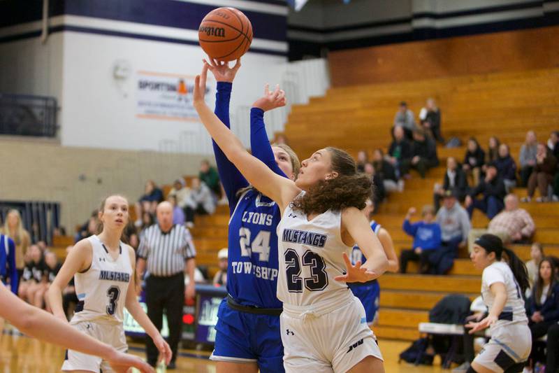 Lyons Kennedy Wanless puts the shot up over Downers Grove South's Addison Bryant at the West Suburban Conference Crossover Championship on Wednesday, Feb.8,2023 in Addison.