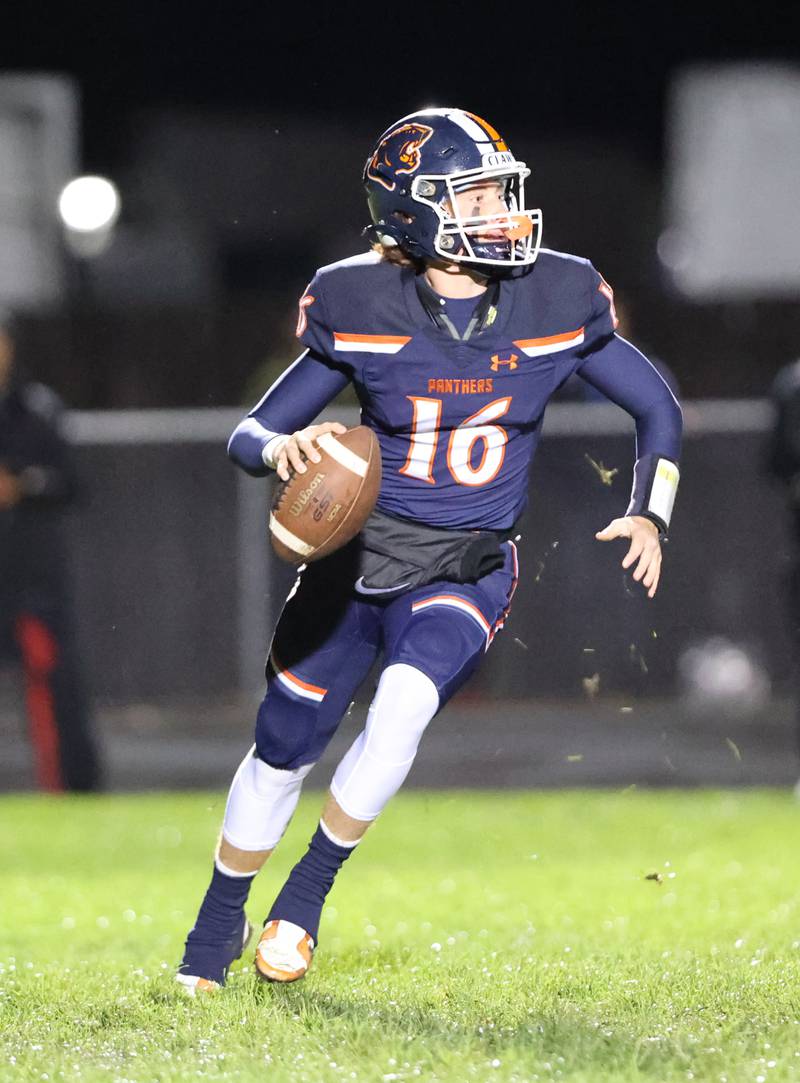 Oswego’s Brett Connolly (16) looks for a receiver against against Yorkville during the boys varsity football game on Friday, Oct. 6, 2023 in Oswego