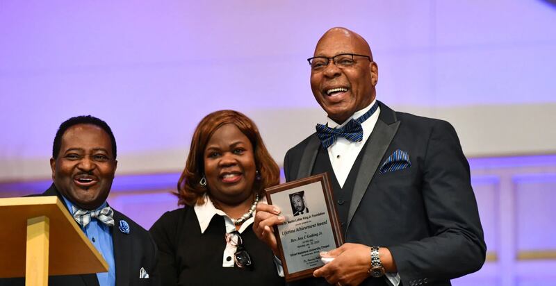 Jess Gathing, a lifelong Kankakee resident, right, accepts the Dr. Martin Luther King Jr. Memorial Foundation’s Lifetime Achievement Award on Monday at College Church of the Nazarene in Bourbonnais during the foundation’s annual Interfaith Prayer Breakfast and Ecumenical Service.