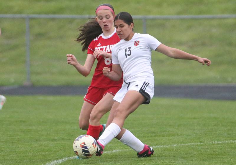 L-P's Savannah Patron kicks the ball away from Ottawa's Georgia Kirkpatrick on Wednesday, April 30, 2025 at King Field in Ottawa.