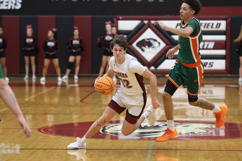Plainfield North’s Ryan Barriball drives around Plainfield East’s Kierre Miller on Tuesday, Dec. 9, 2025 in Plainfield.