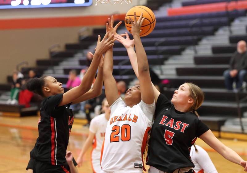 DeKalb's Zora Watts fights for a rebound between two Rockford East defenders during their game Wednesday, Jan. 22, 2025, at DeKalb High School.