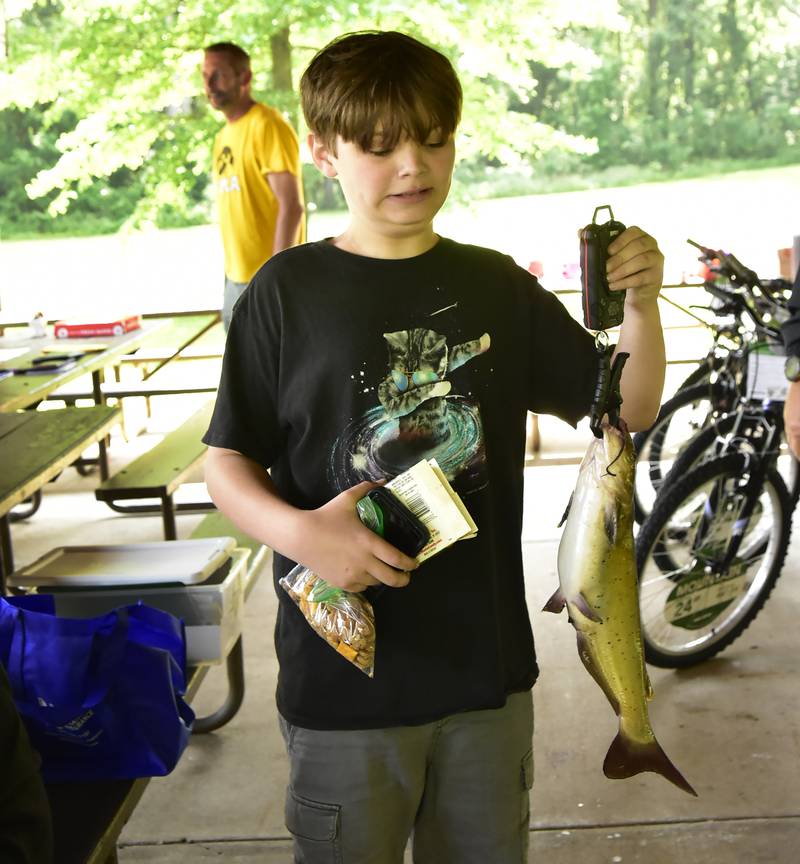 The Prophetstown Police Department hosted the 19th annual Dick Brown Fishing Derby Saturday, June 14, 2025 at Prophetstown State Park. Here, Sam Jones, 11,  holds up his catch which was the second iggest fish of the day, a 2.34 lb catfish. Sam said he caught the fish for his brand new baby sister Zoey.