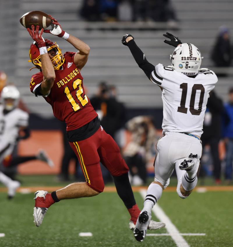 Batavia wide receiver Luke Alwin, left, makes a catch in front of Mount Carmel defensive back Nolan O'Brien during the Class 7A football state title game at Memorial Stadium in Champaign on Saturday, Nov. 26, 2022.