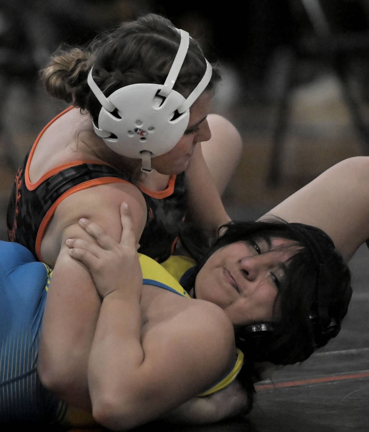 St. Charles East’s Addison Wolf pins Wheaton North’s Jackie Chavez in a 155-pound bout in a girls wrestling meet in St. Charles on Thursday, Dec. 12, 2024.