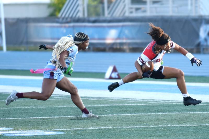 Bradley-Bourbonnais' Nevaeh Brown, right, attempts to hurdle past Kankakee's Damariana Tooles after Tooles pulled her flag during the All-City game at Kankakee Wednesday, Sept. 17, 2025.
