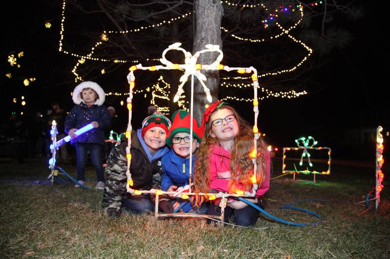 Children pose for a photo at the Annual Lighted Holiday Parade in Downtown Morris on Friday.