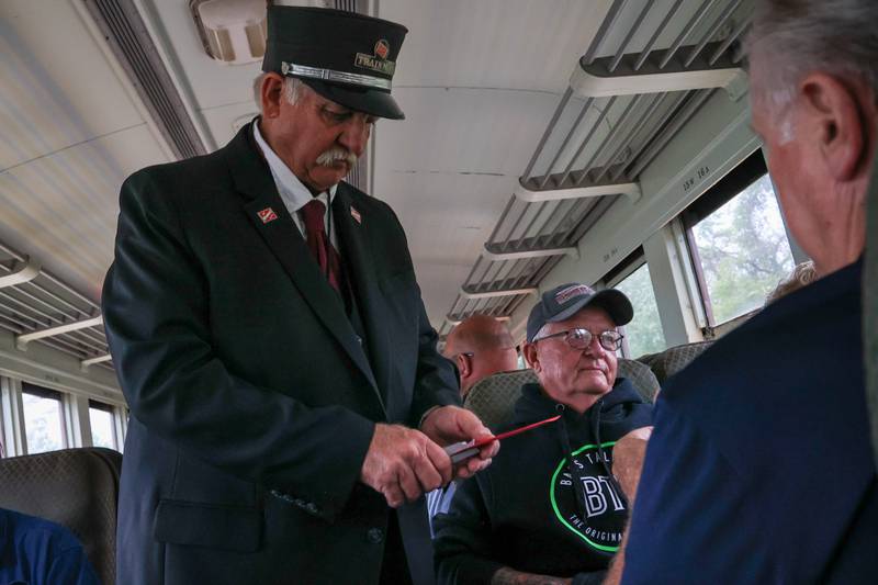 IAIS train staff member hole punches train ticket during train ride on Saturday, September 28, 2024 in Bureau.