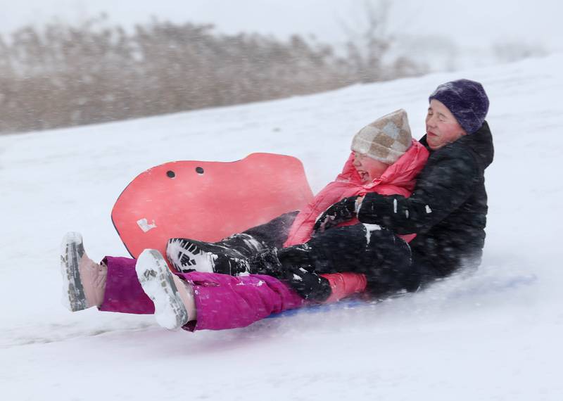 Kendall McMacken, (left) 10, and her brother Camden, 12, from Sycamore, get a face full of snow Saturday, Nov. 29, 2025, as they sled into the wind at the Northwestern Medicine Sled Hill near the Sycamore Park District Community Center.