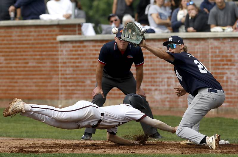 Cary-Grove's Brock Iverson catches the ball as Prairie Ridge’s Gabriel Winkelman dives back to first during the IHSA Class 3A Grayslake Central Sectional semifinal baseball game Wednesday, June 4, 2025, at Grayslake Central High School.
