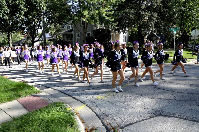 Downers Grove North High School cheerleaders walk in the school’s annual homecoming parade on Friday, Sept. 29, 2023.