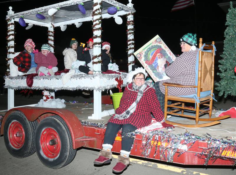 People ride a float during the annual Christmas Parade on Saturday, Dec. 7, 2024 on Peoria Street in Peru.