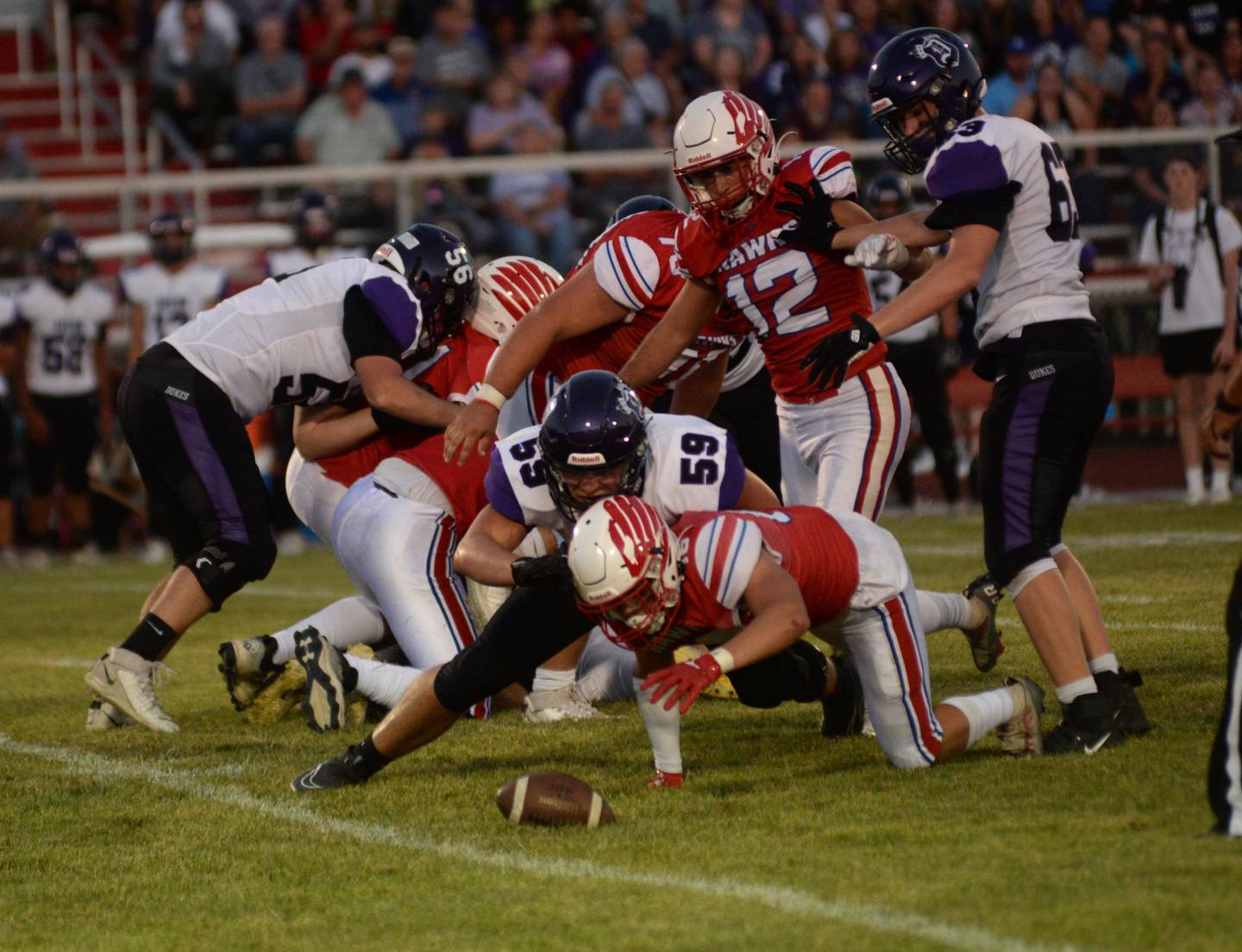 Oregon's Trevor Burkhart (16) dives on a fumble ahead of Dixon's Spencer Thompson (59) on Friday, Sept. 1, 2023 at Oregon High School's Landers-Loomis Field/