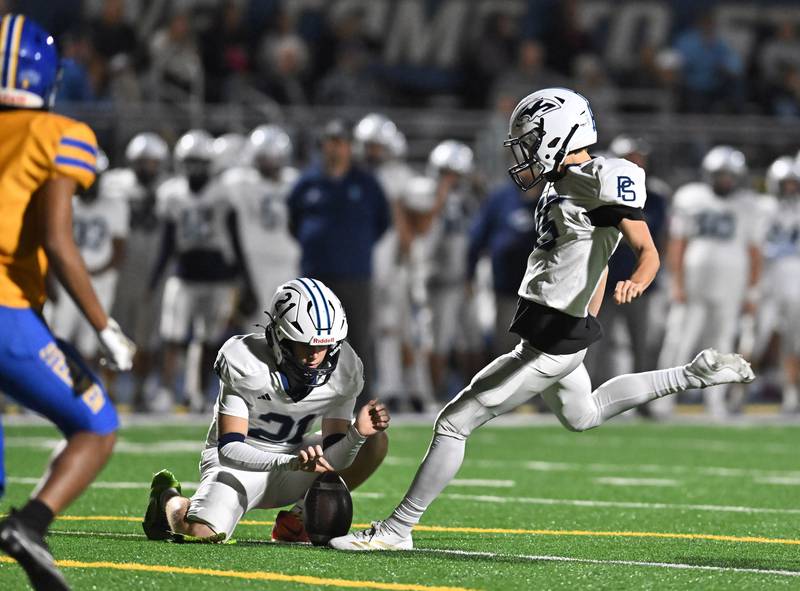 Plainfield South's Nick Lynch (15) kicks a point after during the conference game against Joliet Central on Friday, OCT. 17, 2025, at Joliet.