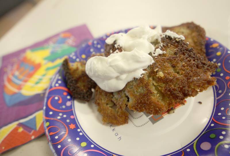 Latkes with sour cream were featured during a Chanukah party at The McHenry County Jewish Congregation Sunday.
