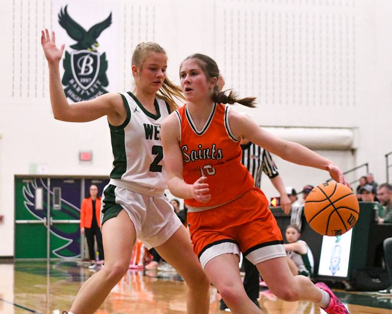 St. Charles East's Kathlyn Bainbridge (10) drives to the basket while being defended by Glenbard West's Katie Meehan (2) during the 4A Sectional championship game on Thursday Feb. 26, 2026, held a Bartlett High School.