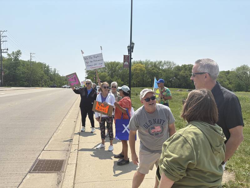 People rally against President Donald Trump in Huntley May 31, 2025.