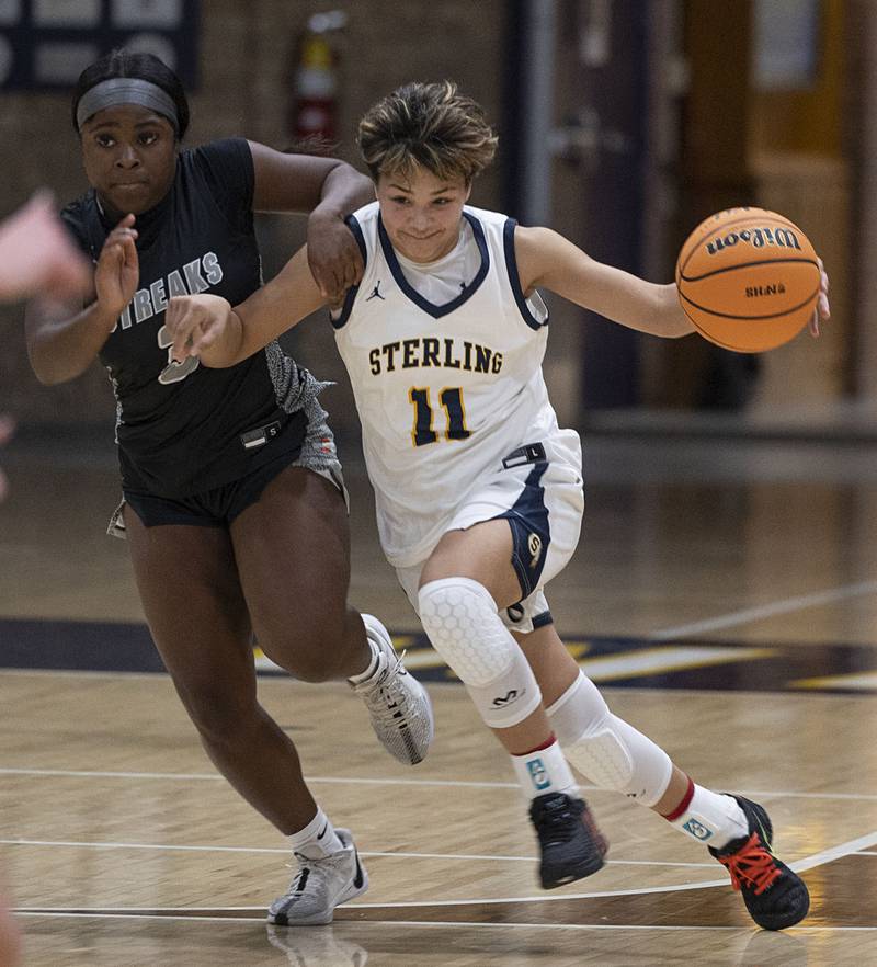 Sterling’s Joslynn James brings the ball up court against Galesburg’s Khloe May Thursday, Dec. 4, 2025.