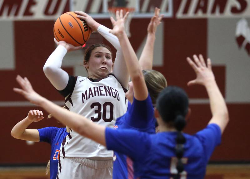 Marengo's Macy Noe shoots the ball over Genoa-Kingston's Arielle Rich during an IHSA Class 2A Marengo Regional semifinal girls basketball game on Monday, Feb. 16, 2026, at Marengo High School.