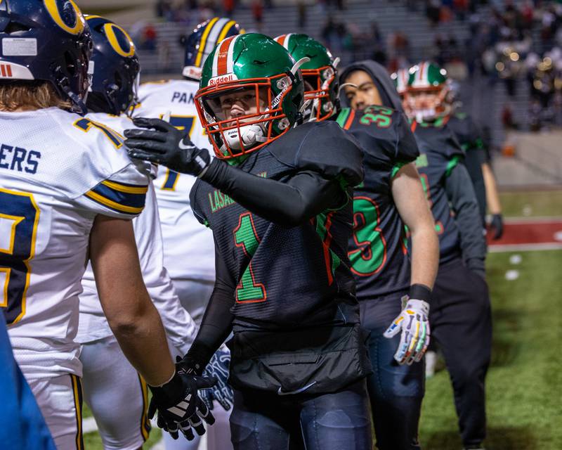 Rafe Helming (1) of L-P leads team in high-five line after loss to O' Fallon on Friday, October 24, 2025 at Howard Fellows Stadium in LaSalle.