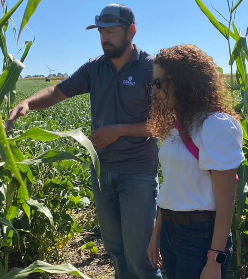 Cornbelt Ag Services' William Anderson talks to state Rep. Mary Beth Canty about ongoing projects at a research farm.
