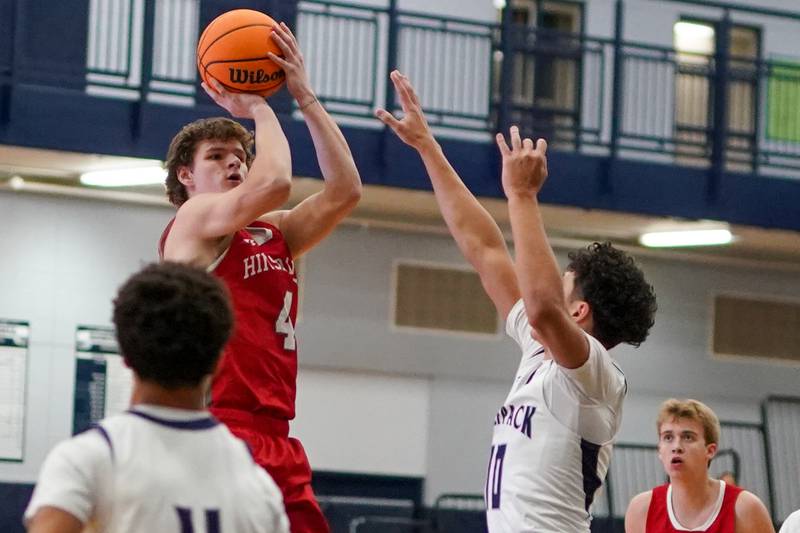 Hinsdale Central's Vincas Buzelis (4) shoots a three pointer against Oswego East's Damien Lewandowski (10) during a hoops for healing tournament basketball game at Oswego East High School on Tuesday, Nov. 26, 2024.