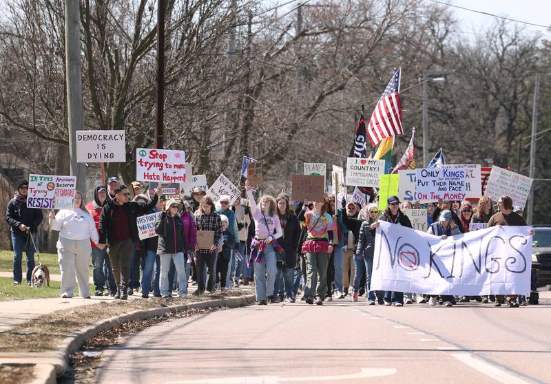Protesters march north Saturday, March 28, 2026, on Sycamore Road in DeKalb during a No Kings march and rally against the federal actions of President Donald Trump and his administration.