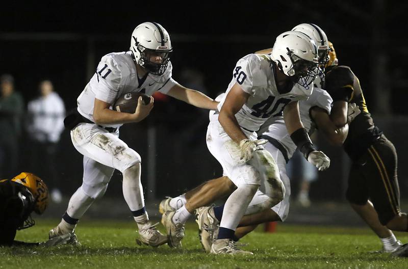 Cary-Grove's Jackson Berndt runs behind his teammate, Logan Abrams during a Fox Valley Conference football game against Jacobs on Friday, Oct. 24, 2025, at Jacobs High School in Algonquin.