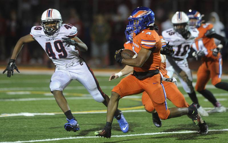 Hoffman Estates' Jashawn Johnson turns the corner for yardage as he outruns Conant's defense in boys football at Hoffman on Friday.
