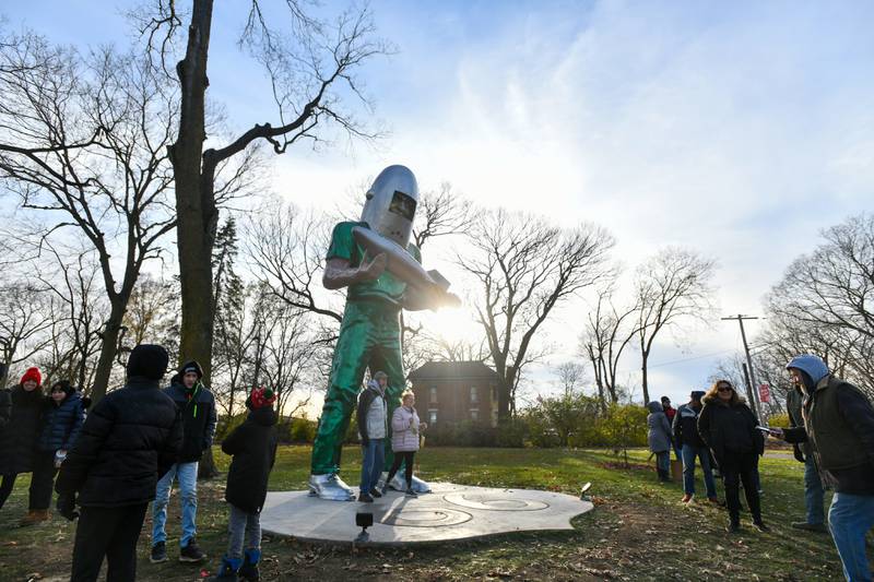 Attendees linger to take photos with the Gemini Giant on Saturday during the Gemini Giant Homecoming event at Wilmington's South Island Park.