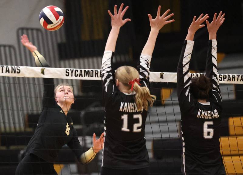 Sycamore's Ava Carpenter tries to beat the block of Kaneland's Haley Swim (left) and Grace Remsen during their match Tuesday, Oct. 1, 2024, at Sycamore High School.