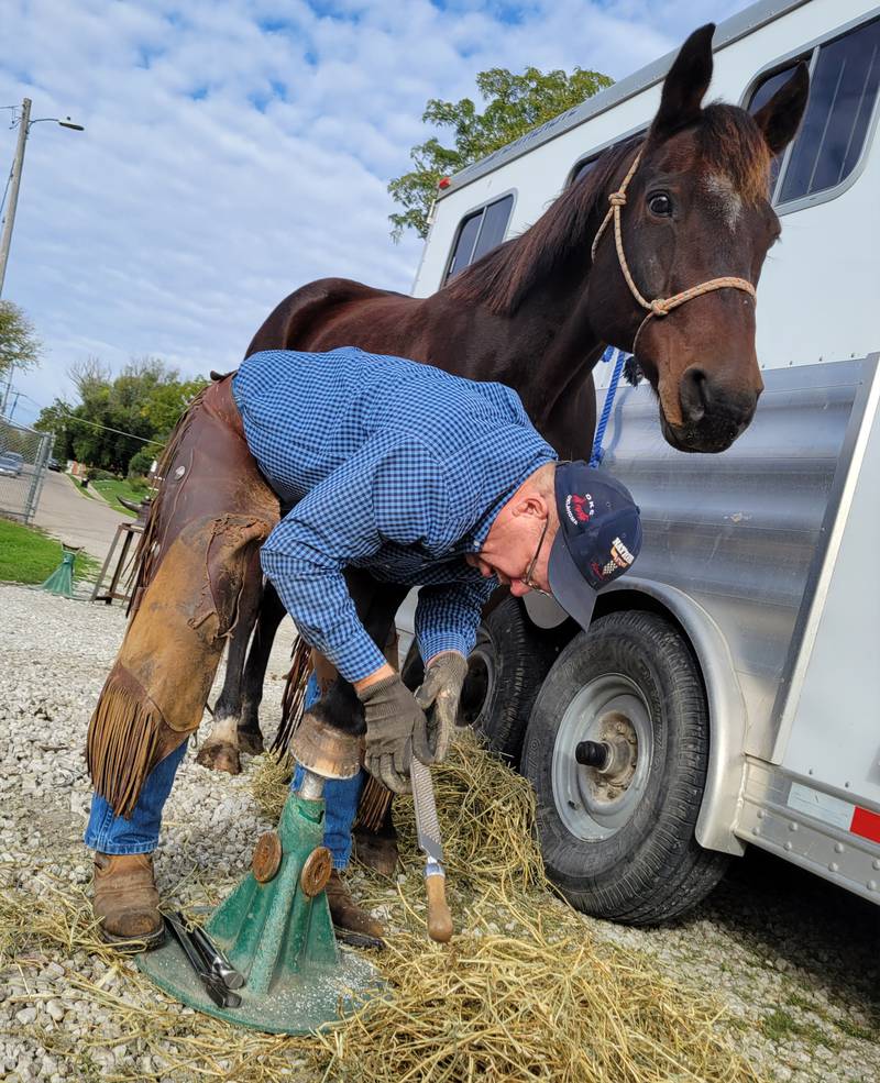 Pontiac's Don Haag, a professional horseshoer. demonstrates the finishing touches on a new shoe he put on Romo, his 20-year-old quarterhorse, to the Marquette FFA class on Friday morning in Ottawa.