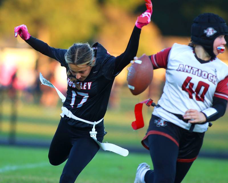 Huntley’s Charlotte Lubarski, left, snags the flag of Antioch quarterback Tanner Ludwig in IHSA Regional varsity flag football action at Crystal Lake Central High School in Crystal Lake on Wednesday, Oct. 8, 2025.