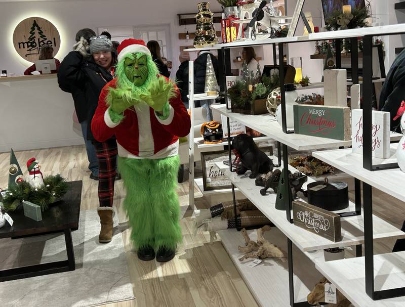 The Grinch was spotted visiting the Mobel store on North Third Street during Oregon's Candlelight Walk on Saturday, Nov. 30, 2024.