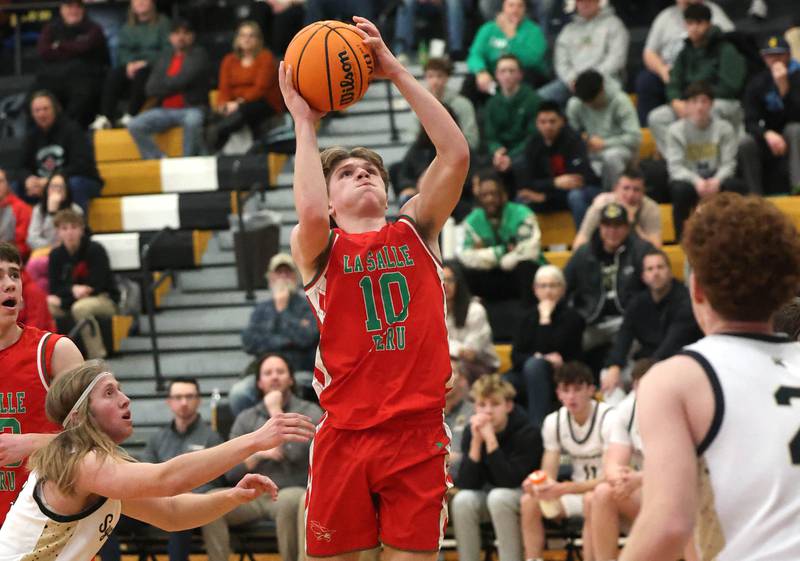 La Salle-Peru's Braylin Bond scores in front of Sycamore's Carter McCormick during their game Tuesday, Feb. 4, 2025, at Sycamore High School.