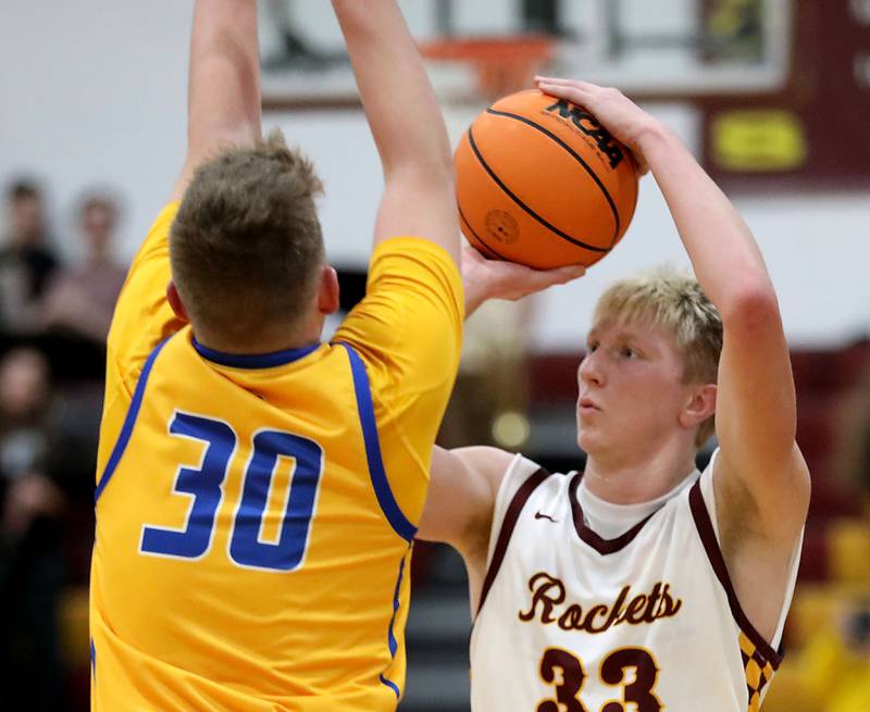 Richmond-Burton's Luke Robinson shoots the ball in front of the pressuring of Johnsburg's Jayce Schmitt during a Kishwaukee River Conference boys basketball game on Tuesday, Jan. 27, 2026, at Richmond-Burton High School.