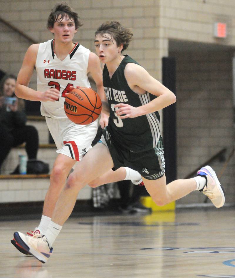 St. Bede's Alex Ankieicz dribbles down court ahead of Earlville's Ryan Bowder in the Marquette Holiday Tournament on Tuesday, Dec. 26, 2023.