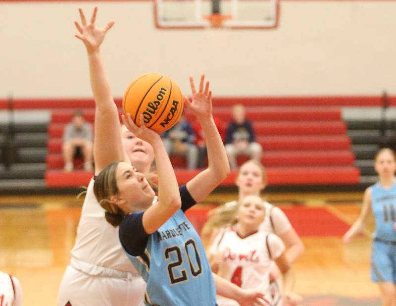Marquette's Kaitlyn Davis eyes the hoop after making her way in the lane past Hall's Jocelyn King on Thursday, Feb. 13, 2025 at Hall High School.