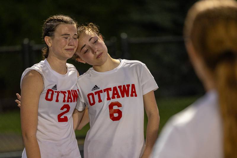 Avery Cap (2) and Kindley Moore (6) of Ottawa mourn after (4-1) loss to Metamora on Tuesday, May 21, 2025 at Malone Field in Metamora.