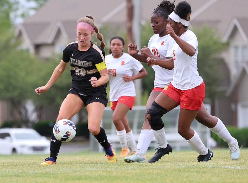 Sycamore's Cortni Kruizenga looks to take a shot in front of two Rock Island defenders Friday, May 22, 2026, during their Class 2A regional championship matchup at Sycamore High School.