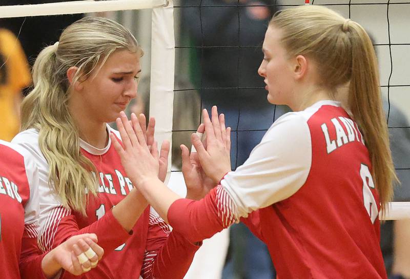 L-P's Kelsey Frederick and Maggie Boudreau hi-five after loosing to Washington during the Class 3A Sectional final game on Thursday, Nov. 6, 2025 in Sellett Gymnasium at L-P High School.