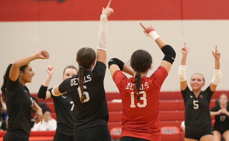 Members of the Hall High School volleyball team react after defeating Mendota on Tuesday, Sept. 13, 2024 at Hall High School.