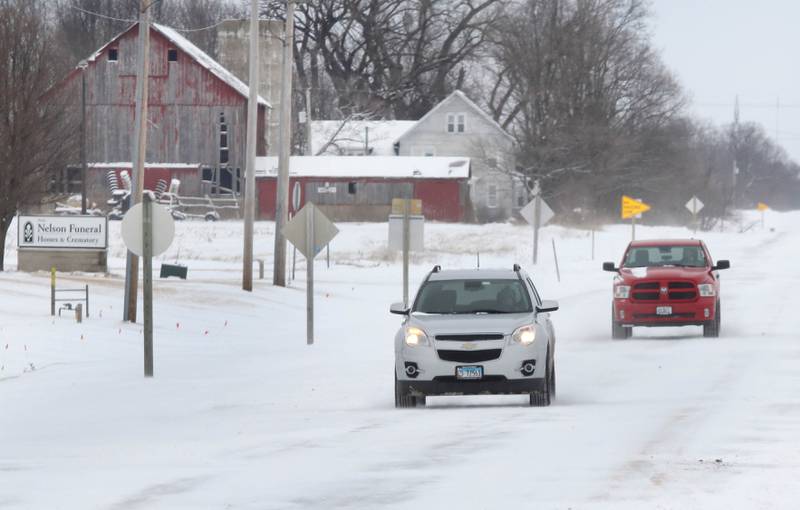 Vehicles carefully make their way down Route 23 near Waterman Wednesday, Feb. 2, 2022, as blowing and drifting snow covers the pavement. Snow overnight and into Wednesday made travel hazardous in parts of DeKalb County.