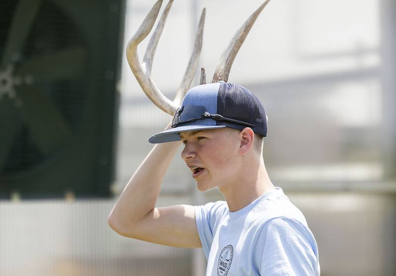 Landon Kukowski, vice president of the Sterling High School FFA, talks to a group of third graders about antler shedding Thursday, May 11, 2023, during Farmapalooza.