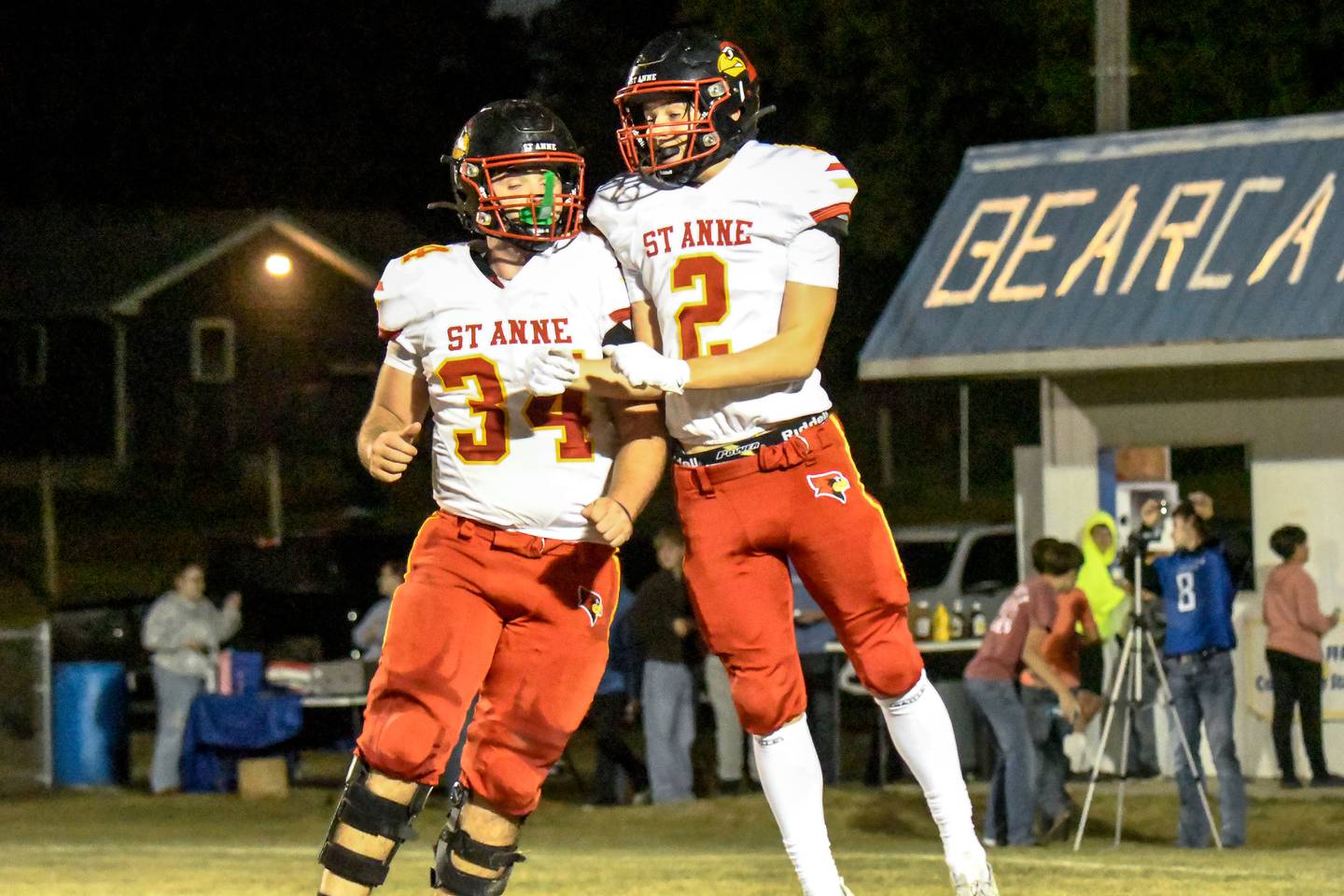 St. Anne’s Brandon Schoth and Matthew Langellier celebrate a touchdown during St. Anne’s 61-28 victory over Milford-Cissna Park on Thursday, Oct. 16, 2025.