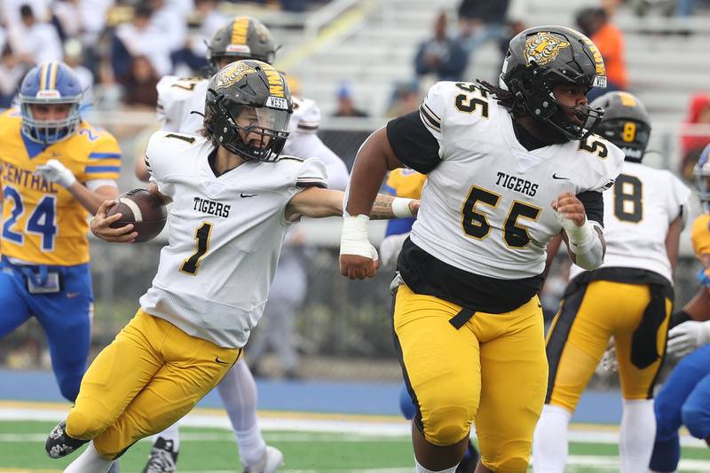 Joliet West’s Antonio Brooks follows the block of John Swift against Joliet Central on Saturday, Sept. 28, 2024 in Joliet.