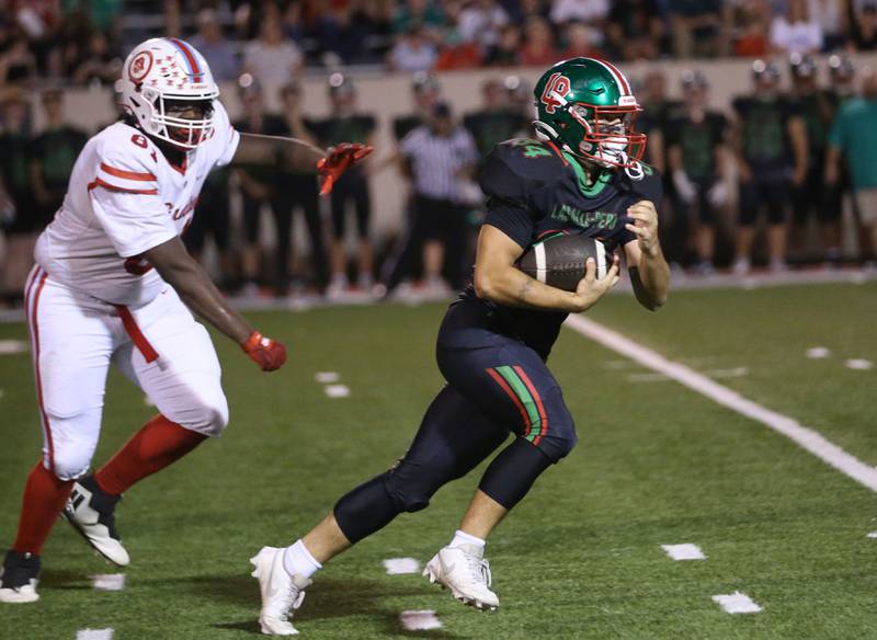 L-P's Easton Moriarty sprints down the field past Ottawa's Stephon Patrick on Friday, Oct. 3, 2025 at Howard Fellows Stadium.
