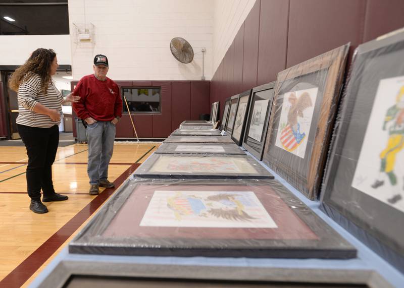 Mike Johnson of Westmont discusses his art with Patty Suchy of Clarendon Hills  at the Westmont Community Center Art Show Sunday March 19, 2023.