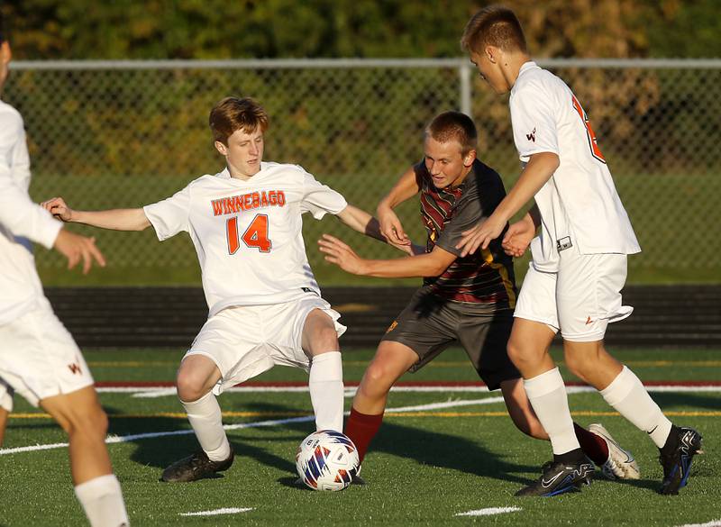 Richmond-Burton's Forest Wells takes he gains control of the ball between Winnebago's Alex Wyant (left) and Brandon Melin to score a goal during the IHSA Class 1A Richmond-Burton Regional Final soccer match Tuesday, Oct. 17, 2023, at Richmond-Burton High School in Richmond.